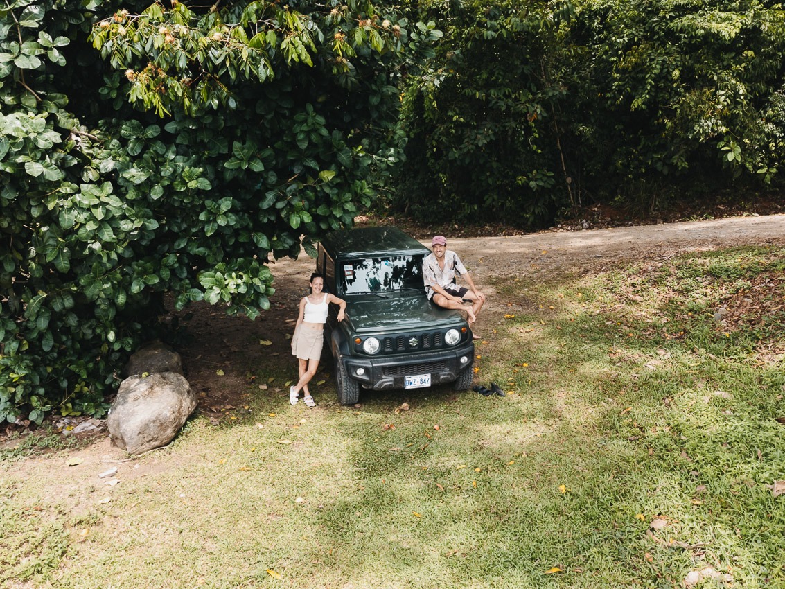 a couple leaning at a car