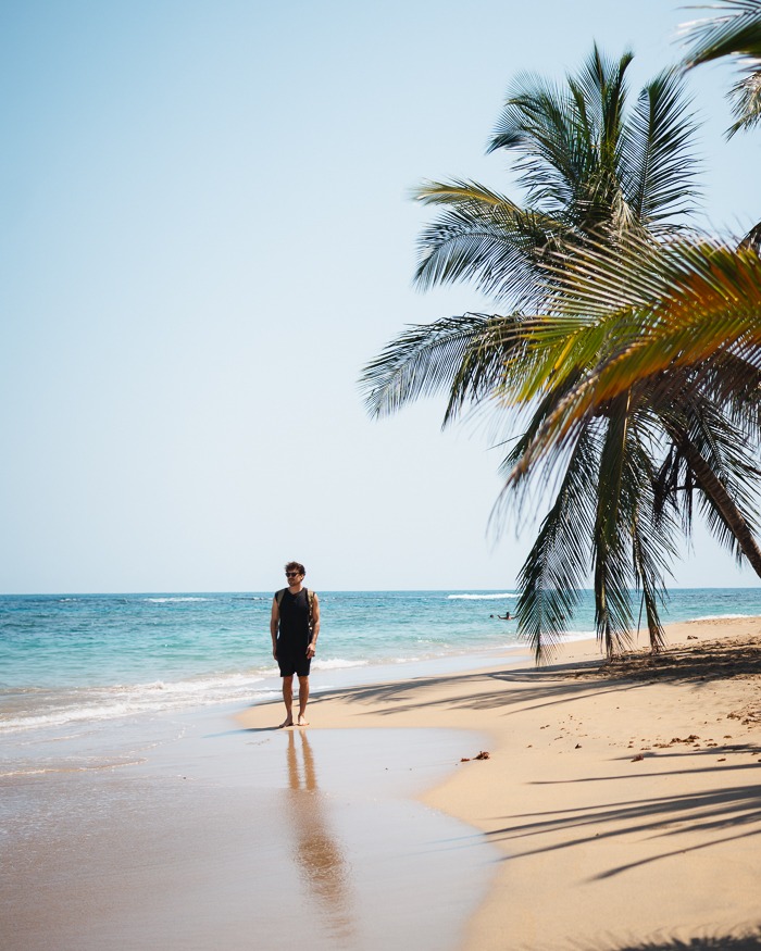 a man walking down the Beach in Punta Uva, Puerto Viejo