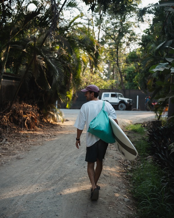 a man with a surf board in Costa Rica