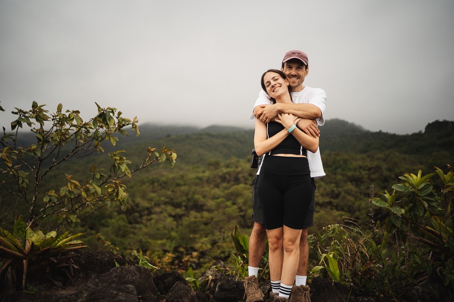 a man and a woman in front of el Arenal volcano in Costa Rica