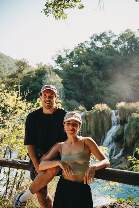 A couple in front of a waterfall in Krka National Park